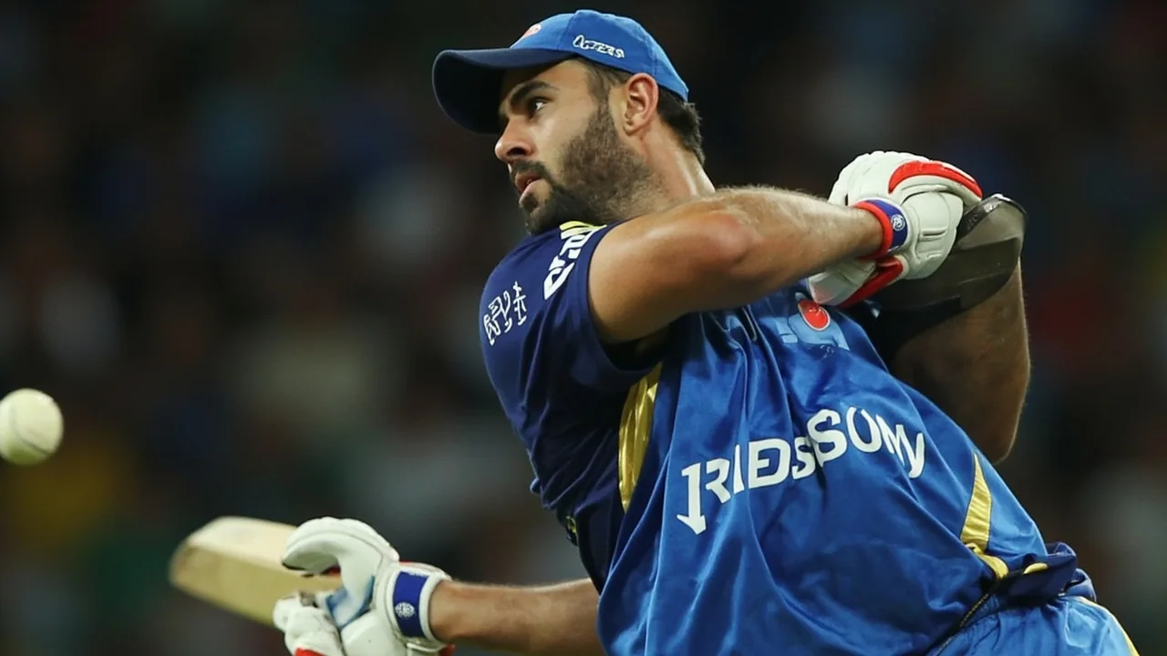 Tight sideline action frame showing an IPL batter in a power-play stance at the crease, capturing the franchise-level on-field product that drives the $20.6 billion league valuation
